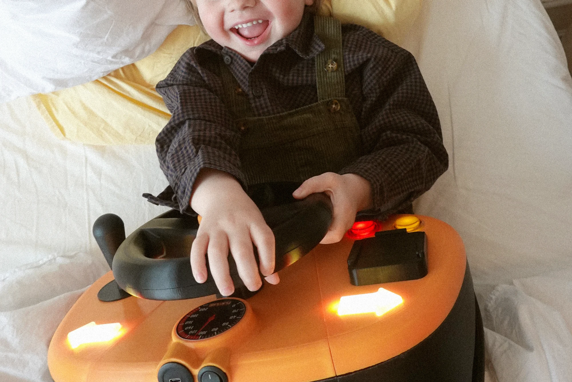 kid playing with toy steering wheel designed for children hospitals